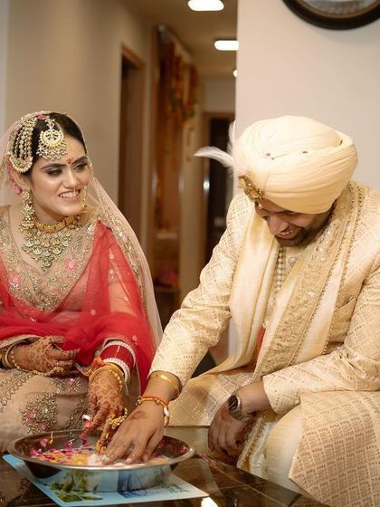 A candid moment from a post-wedding game, capturing the couple's playful interaction and smiles as they search for the ring.