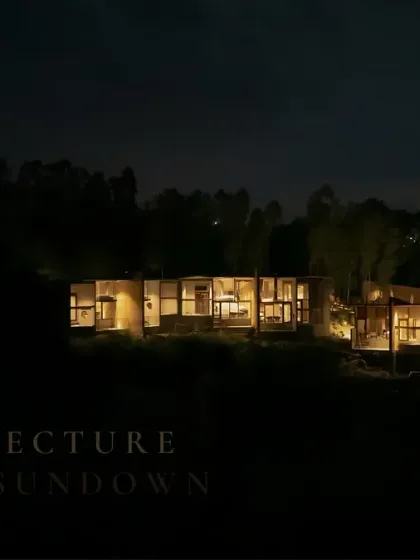 Glow mode: ON. This eco-resort, nestled in a forest, is lit thoughtfully after sundown, creating a warm and inviting presence that respects the natural surroundings.