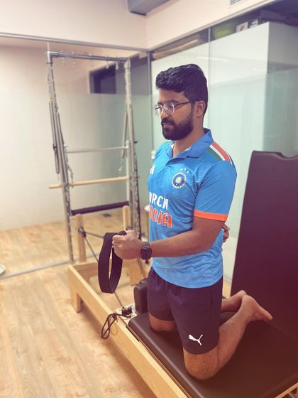 A client works on shoulder stability and control using the Pilates reformer. These targeted exercises are fundamental for anyone recovering from a shoulder injury or looking to improve upper body function.