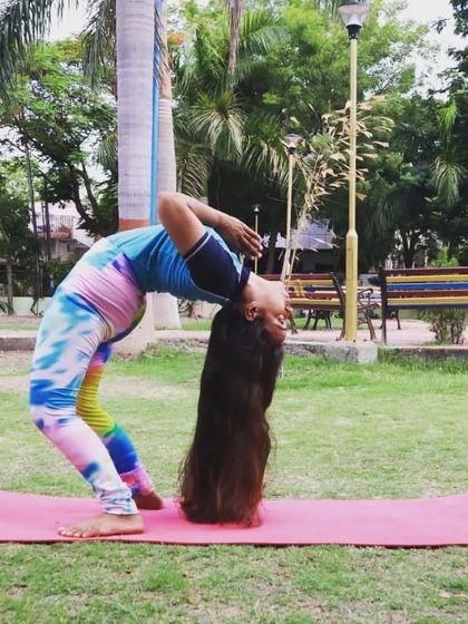 Practicing a deep backbend, Ustrasana (Camel Pose), in the park. The fresh air and open space add another layer of joy to my practice, showing that yoga can be done anywhere.