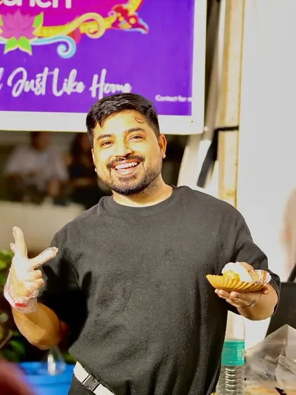 Ankur, smiling and serving a customer at one of our events. We love interacting with everyone who tries our food.