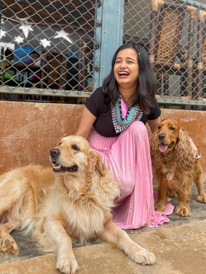 A moment of laughter and joy shared between a visitor and two of our friendly dogs.