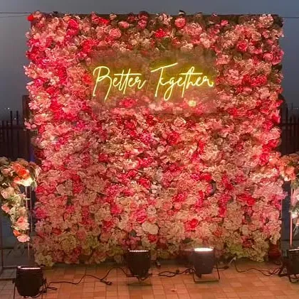 It's the personal touches that make a wedding unique. We love adding elements like this custom "Better Together" neon sign against a dense wall of pink and red roses, creating the perfect photo-op for you and your guests.
