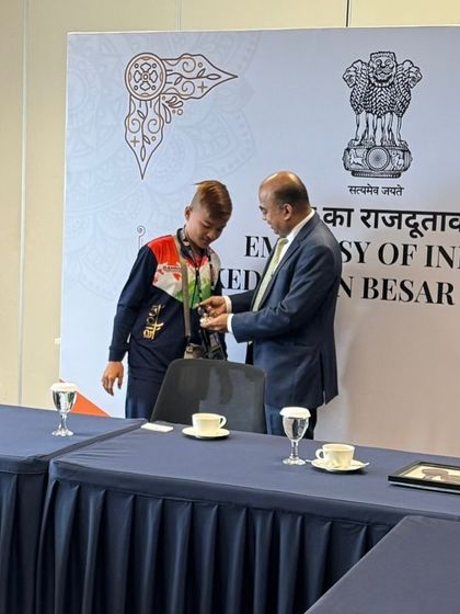 Another shot of our young champion being honored by the Deputy Chief of Mission. This experience builds confidence and reinforces the importance of their hard work.