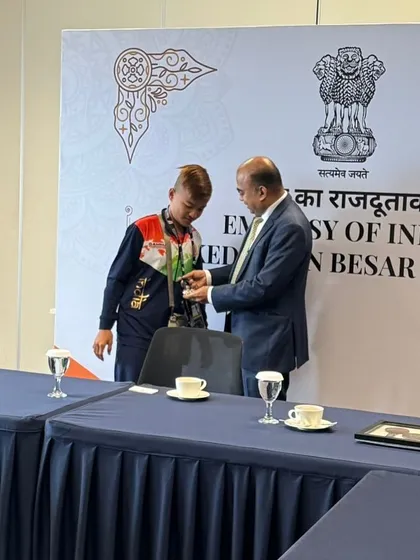 Another shot of our young champion being honored by the Deputy Chief of Mission. This experience builds confidence and reinforces the importance of their hard work.