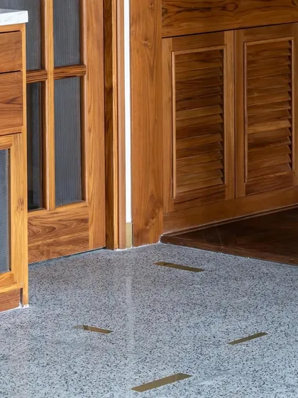 The flooring detail from the '9PM' project. Brass inlays are set into the terrazzo floor, creating a subtle yet elegant pattern that guides movement and adds a touch of bespoke luxury to the space.