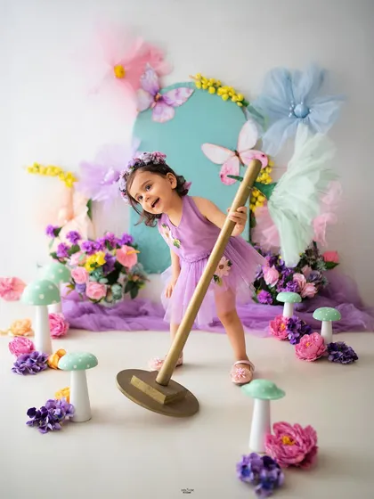 Having a little fun while cleaning up the magic garden! Candid moments like these are what make a photoshoot so special.
