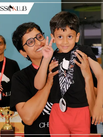 It's all about encouragement and fun. One of our youngest winners celebrating his achievement with a team member, reflecting the supportive family atmosphere we nurture at the Klub.