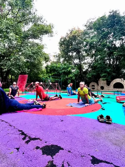 Our members performing cobra stretches in the colorful kids' play area at our Mahalaxmi batch. We make fitness fun and accessible for everyone.