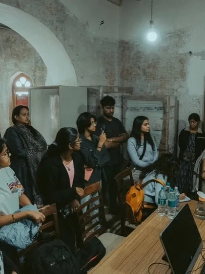A group of students listens intently during a session for The Restoration Clinic. These workshops are designed to be intimate and interactive, providing direct access to experts and fostering a collaborative learning environment.