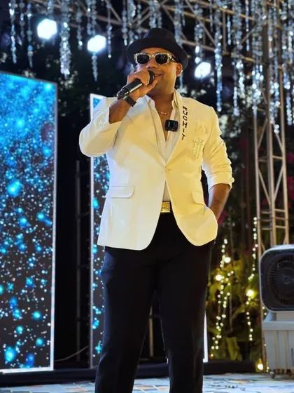 Here I am, in action, against a backdrop of dazzling LED screens. As a professional host, I seamlessly integrate with the stage production to create a visually stunning and cohesive show.