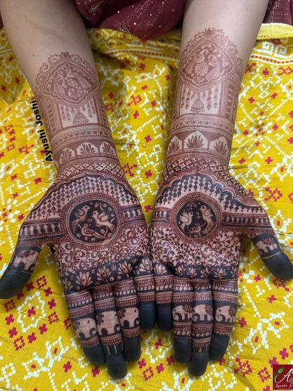 Another shot of the rich henna stain, showing the clarity of the intricate details like the elephants on the fingers and the fine lines in the bird motifs.
