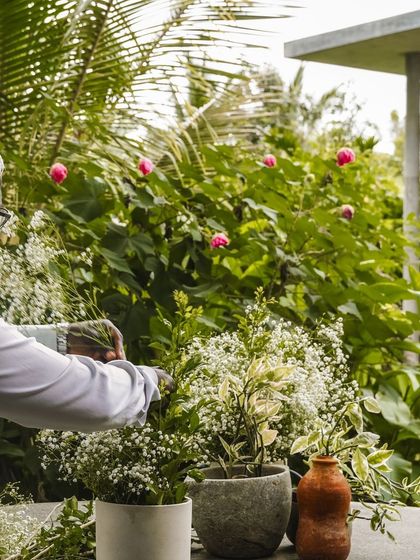 The beauty of our events is in the details. Here, a member of our team is carefully arranging fresh flowers, adding a touch of natural elegance to the decor for a day retreat we hosted.