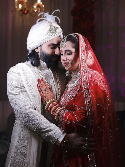 This is the heart of a wedding day. An intimate portrait of the bride and groom in their traditional attire, sharing a quiet moment together. I focus on capturing the deep connection and emotion that you will want to remember forever.