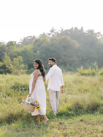 A playful "follow me" style shot as the couple walks through a field. It feels spontaneous and full of movement, telling the story of their journey together.
