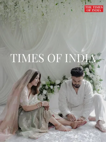 A feature in the Times of India for a celebrity wedding, showcasing a tender moment against a backdrop of soft white florals and drapery. This design was all about creating an intimate and romantic atmosphere.