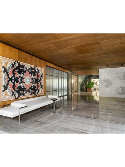 The far end of the K Residence lobby, where the staircase and service areas are located. Large sliding glass doors allow natural light to pour in from the living and dining rooms, maintaining a sense of openness.