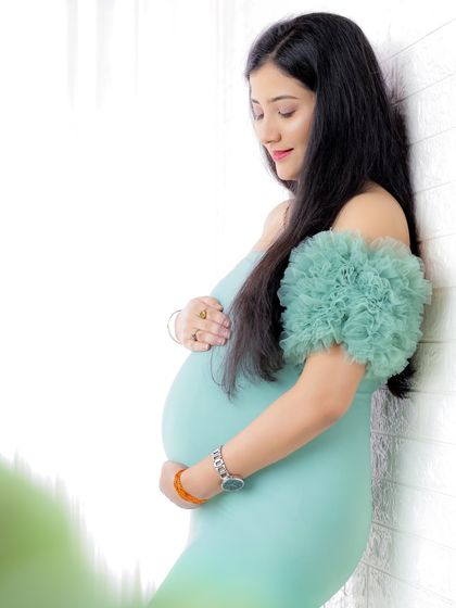 These portraits feature a lovely mint-colored ruffled gown, perfect for creating a soft, serene, and elegant maternity look.