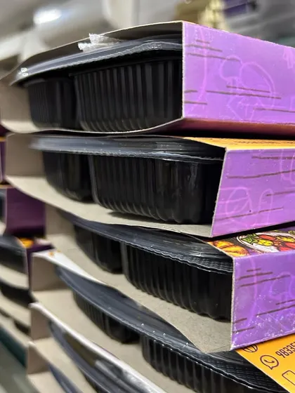 A side view of the stacked meal boxes, showing the compact and easy-to-transport design.