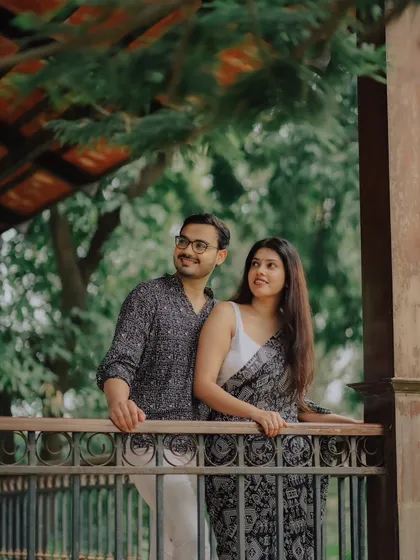 Looking towards the future together. This photo of Jayashree and Anand in traditional wear captures a hopeful and romantic moment in a beautiful garden setting.