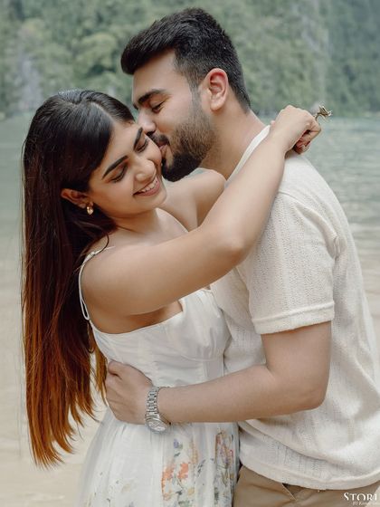 An intimate and joyful moment between Kunal and Disha on a beach in Thailand, capturing their genuine connection.