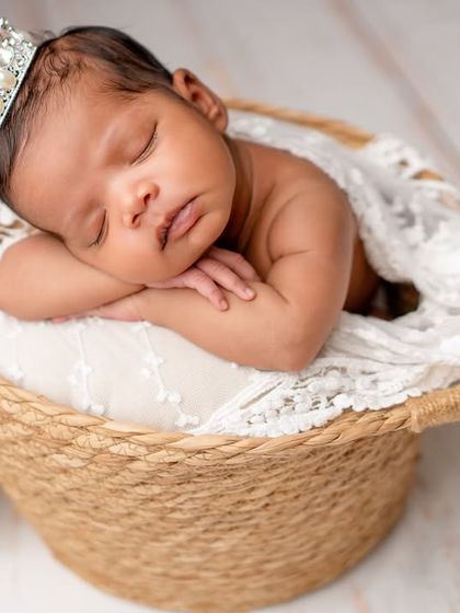 A royal welcome for this little one, sleeping peacefully with a tiny crown.