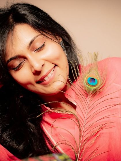 A peaceful smile with eyes closed. This serene portrait captures a moment of pure contentment.