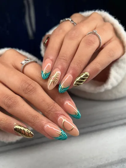 A full view of both hands, showcasing the balance and artistry of this celestial-themed manicure. The combination of hand-painted art and sculpted gold creates a rich, textured look.