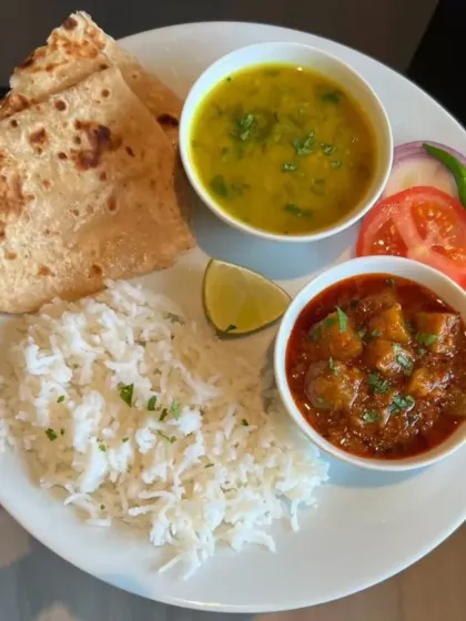 Sometimes, the simplest meals are the most satisfying. This plate of steamed rice, dal, aloo sabzi, and roti is pure comfort food that soothes the soul.