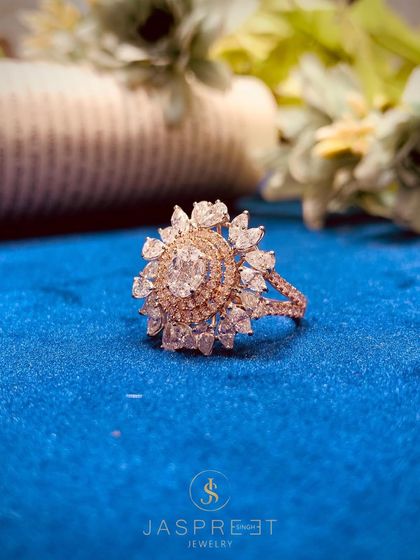 A stunning floral-inspired cocktail ring crafted with a central oval diamond and a halo of marquise-cut diamonds. This sold piece was a favorite for its radiant, sun-like appearance.
