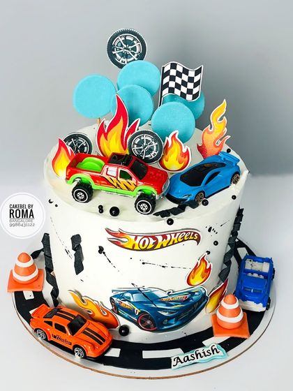 A high-octane Hot Wheels cake for Aashish's first birthday. The design features a racetrack, flames, and several toy cars for extra fun.