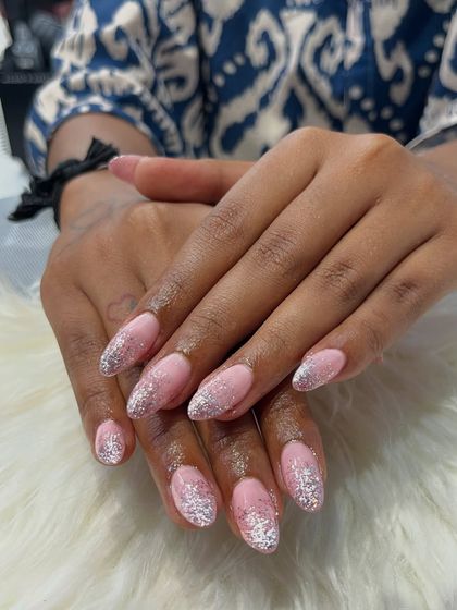 A different view of the glitter gradient extensions, showing how the sparkle catches the light. The seamless blend of the glitter into the pink base is key to making this look so polished and professional.