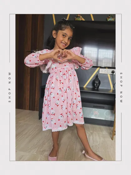 Another look at our popular pink Santa frock, perfect for any little girl who wants to feel festive and comfortable during the holidays.