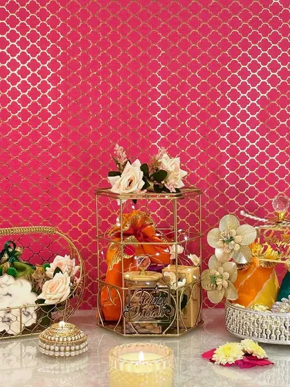 A beautiful display of my diverse Diwali hamper collection. You can see the golden birdcage hamper, a silver crystal-top basket, and a golden mesh basket, each curated with a unique assortment of dry fruits, sweets, and decorative diyas.