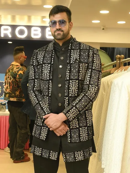 A front-facing view of the bold black and silver patterned jacket, showcasing its intricate design and sharp tailoring.