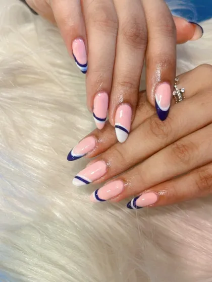 A closer look at this abstract French manicure. The design features a split tip with both white and dark blue, creating a unique and eye-catching geometric effect.