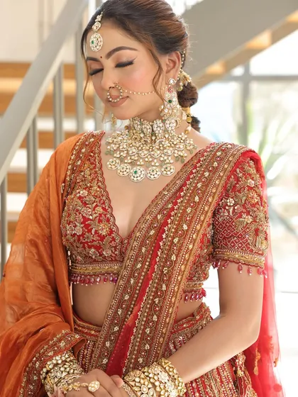 Another detailed shot of the blouse and jewelry. The deep V-neckline and the heavy choker set create a balanced and glamorous bridal look.