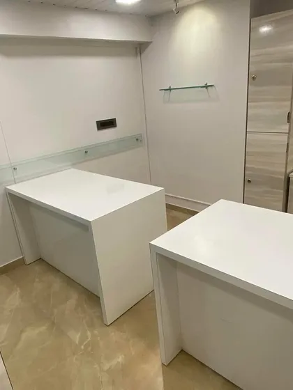 This is a look at the minimalist and functional workstations I designed for CA Suneet Rastogi's office. The space features clean white desks, frosted glass privacy panels, and integrated storage solutions. My focus here was on creating a bright, uncluttered environment conducive to focused work.