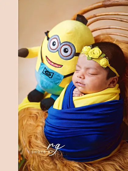 A close-up of the adorable newborn minion, peacefully asleep. We use creative wrapping techniques to match the theme.