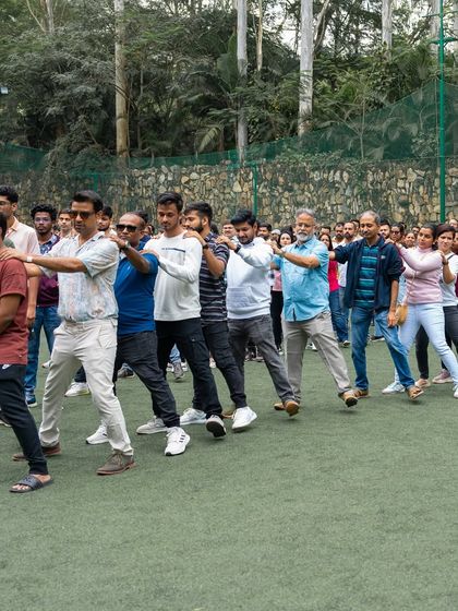 Ditch the boardrooms for some excitement. A team gets into formation for a group activity on the lawn.