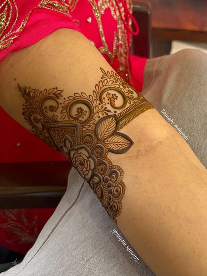 Another detailed shot of Anam's forearm, showing the combination of floral and geometric elements.