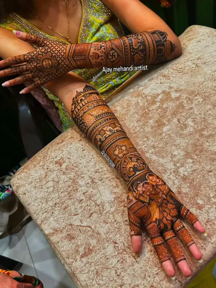 A unique pose showing both the front and back of the hands, covered in a dense bridal design with traditional Indian motifs.
