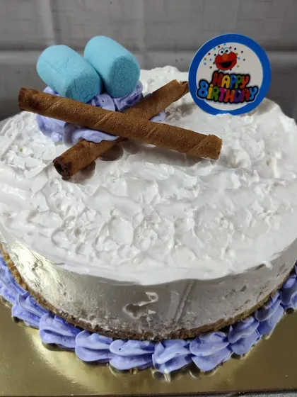 A fun and simple birthday cake, perfect for a casual celebration. This one is topped with soft marshmallows, crunchy chocolate wafer rolls, and a colorful "Happy Birthday" topper.