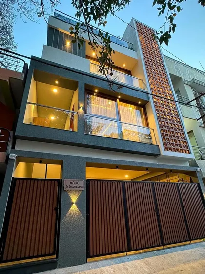 A night view of our compact urban residence in South Bengaluru. We designed this 4BHK home on a 750 sqft plot, using strategic lighting and a vertical brick jali to create a striking facade with great curb appeal.