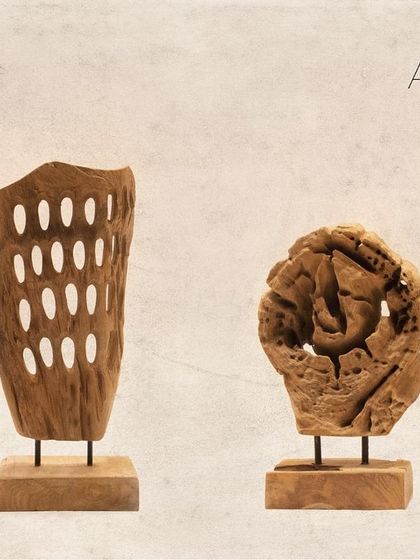 A pair of contrasting artifacts. One features the perforated design, while the other is a more solid, gnarled piece of teak, showcasing the diverse forms found in nature.