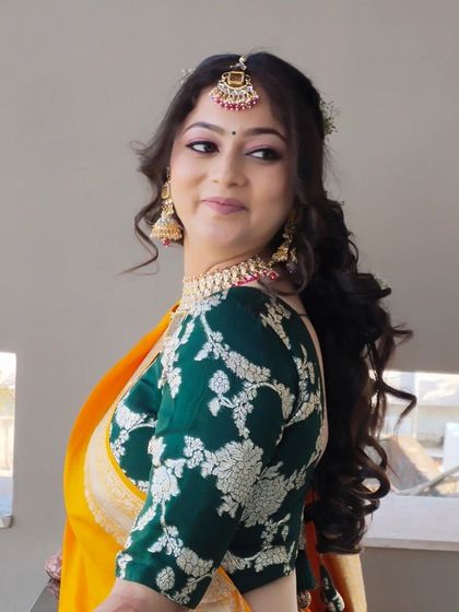 A side profile of the bride, showing off her beautiful smile and the soft, romantic hairstyle.