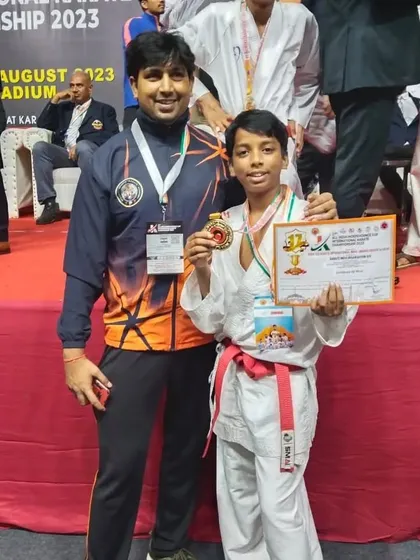 A moment of pride with one of our young gold medalists at the 17th All India Independence International Karate Championship.