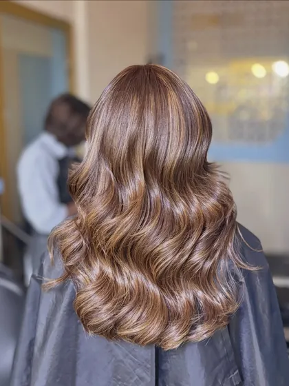 These are our Ginger Layers. The warm, ginger-toned highlights add a beautiful warmth and dimension to the hair, styled in classic waves.
