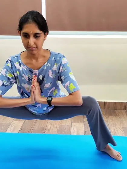 A student practices Malasana (Garland Pose). This deep squat is excellent for opening the hips and groin, and it also helps to improve ankle and back flexibility.
