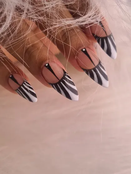 This is where nail art becomes a true statement piece. I created this sharp stiletto set featuring a bold zebra print, but with a modern twist using negative space. The clean lines and graphic pattern showcase precision and a flair for edgy, high-impact designs.